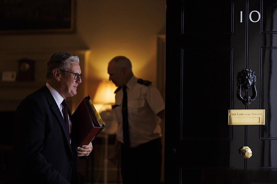 File:Keir Starmer leaves 10 Downing Street, smiling, view from inside downing street, famous door in shot 2317462 (cropped).jpg